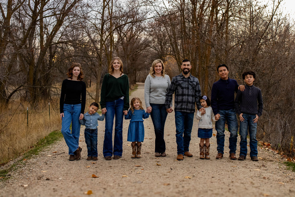 The Childers family walking a tree-lined path together